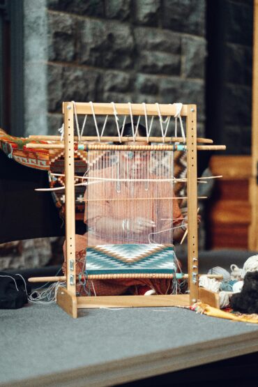 Close-up of a traditional loom in Honolulu showcasing colorful textile weaving.